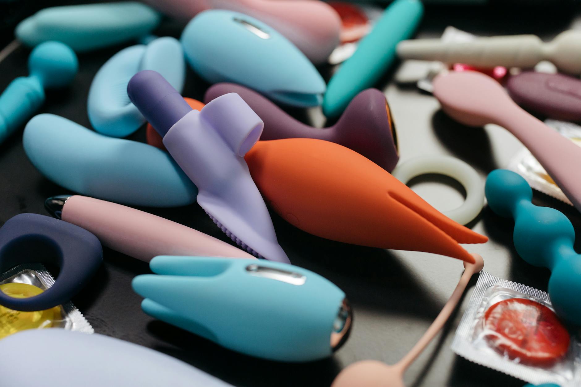 An array of vibrant adult toys arranged together on a neutral surface