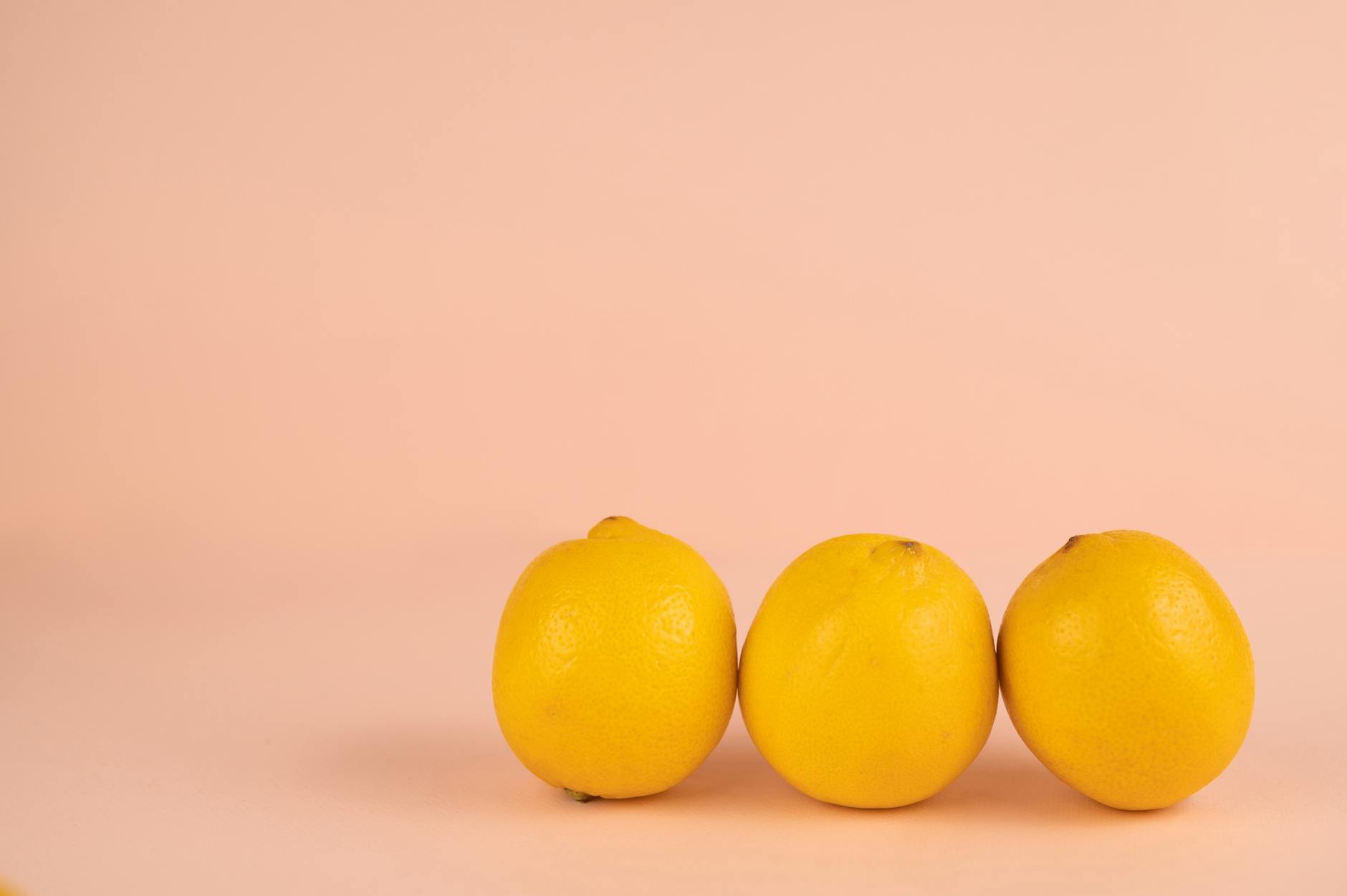 Bright ripe lemons on a pastel background, representing fresh biological cycles