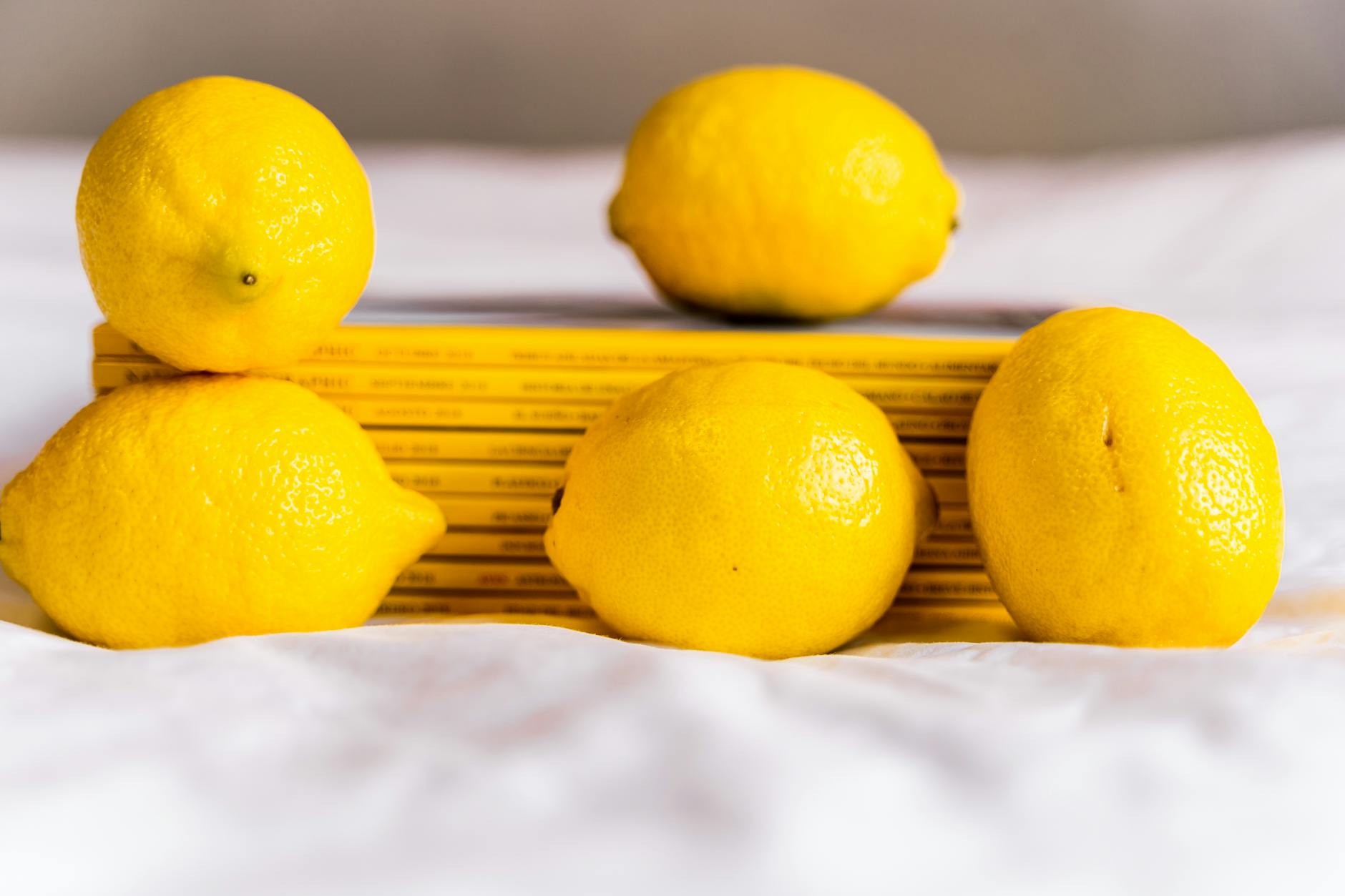 Hands cupping fresh lemons on a brown surface, symbolizing gentle care and sensitivity